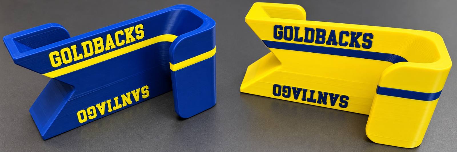 Two updated Sports Bag Fence Hooks in blue and yellow, with team-name and personalized lettering